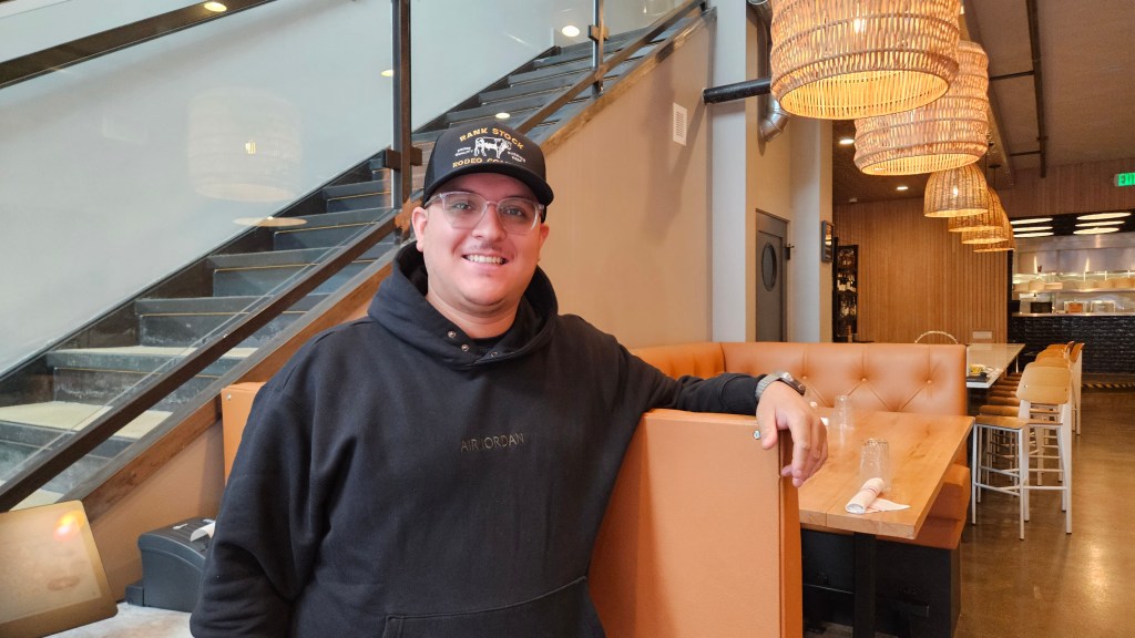 man leaning against a restaurant booth