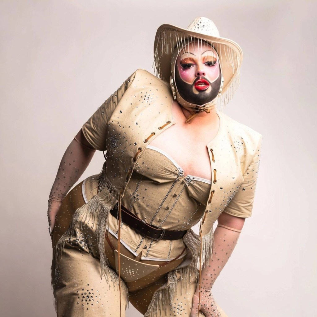 A drag queen in a tan outfit