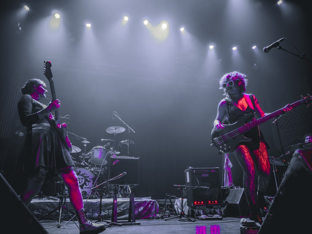 two women in a band performing on stage