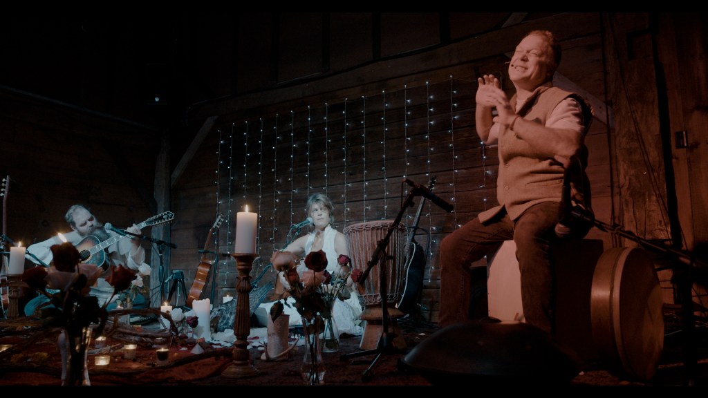 three musicians sitting and performing