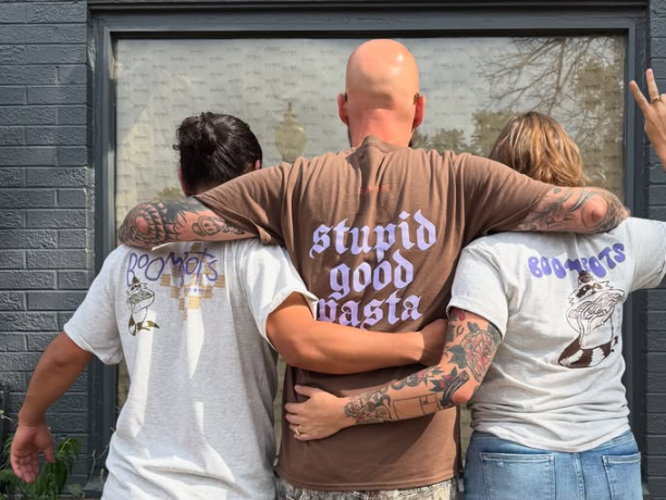 back of three people in t-shirts