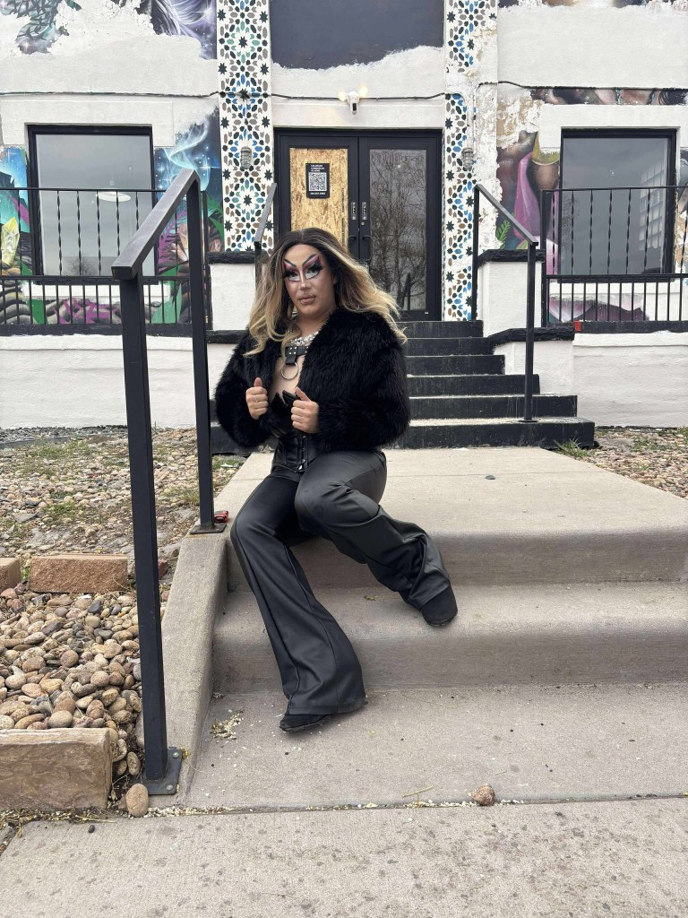 A drag artist in a black outfit