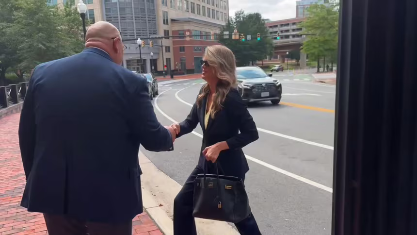 woman in suit shaking hand
