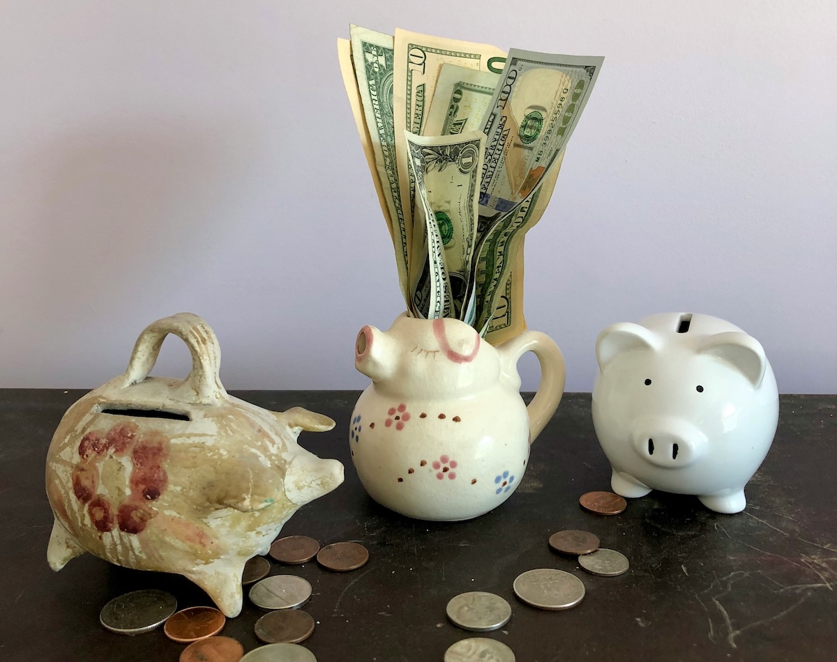 piggy bank with change and dollar bills