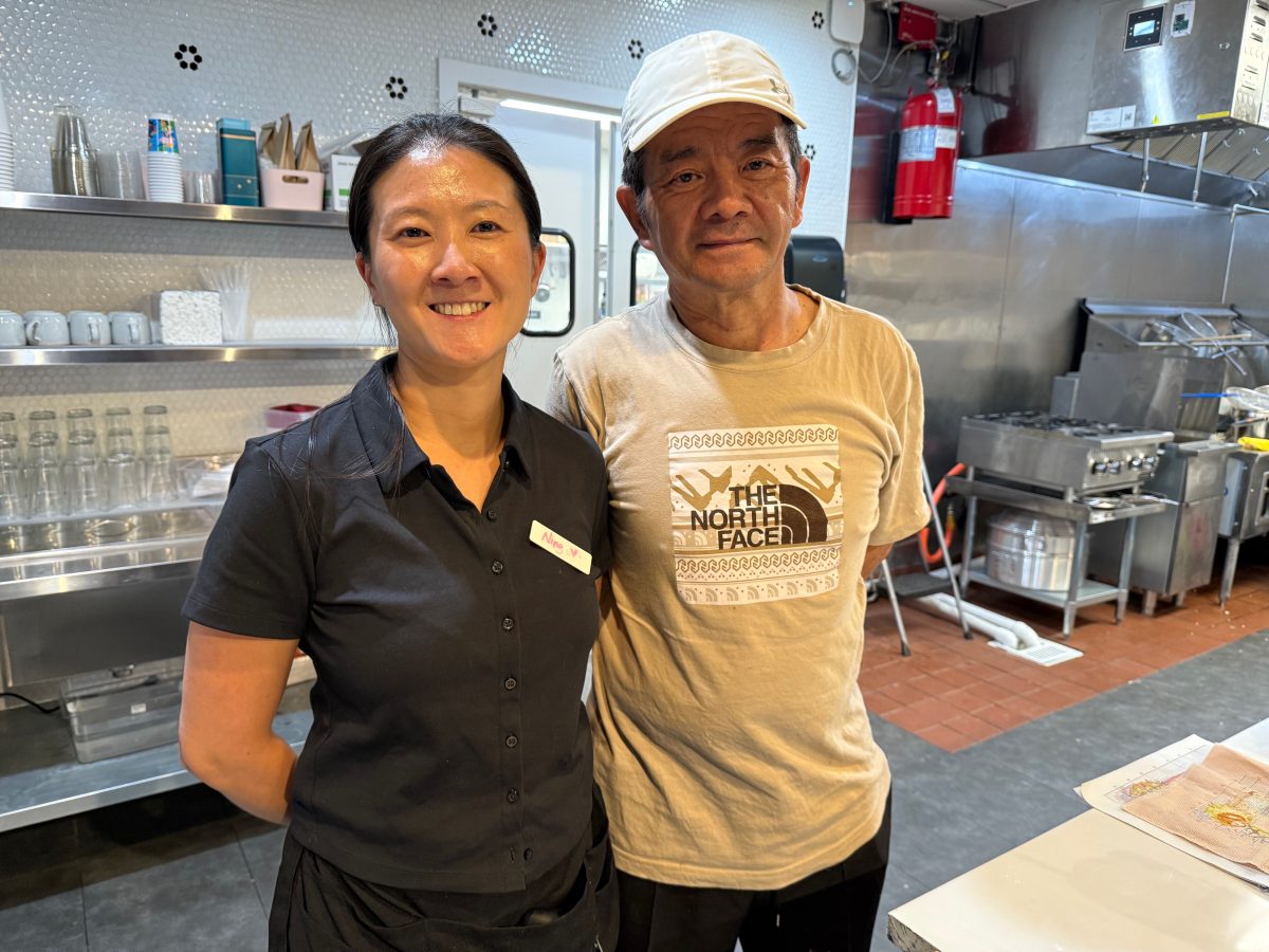 two people posing in a kitchen