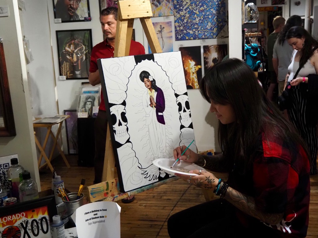 An artist paints at an event