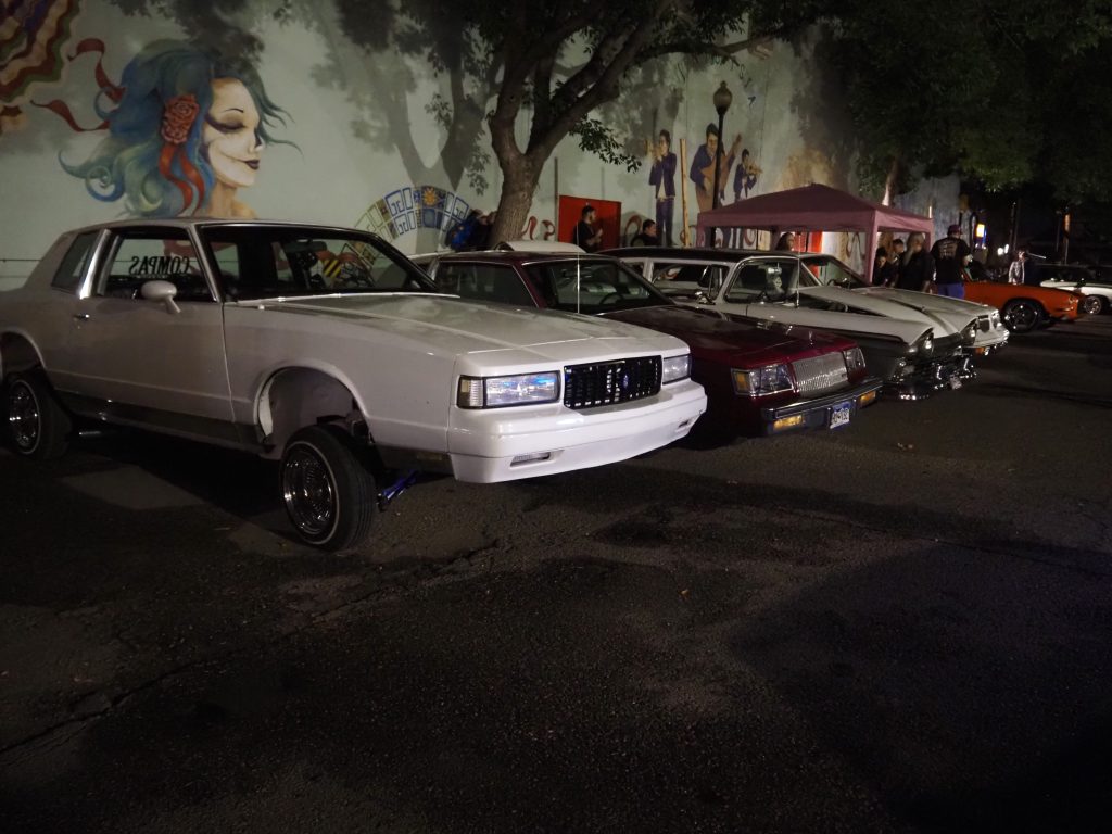 Low-rider cars parked in a parking lot