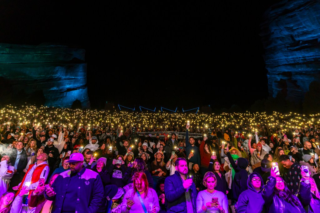 A photo showing the Red Rocks crowd lit with phone flashlights.