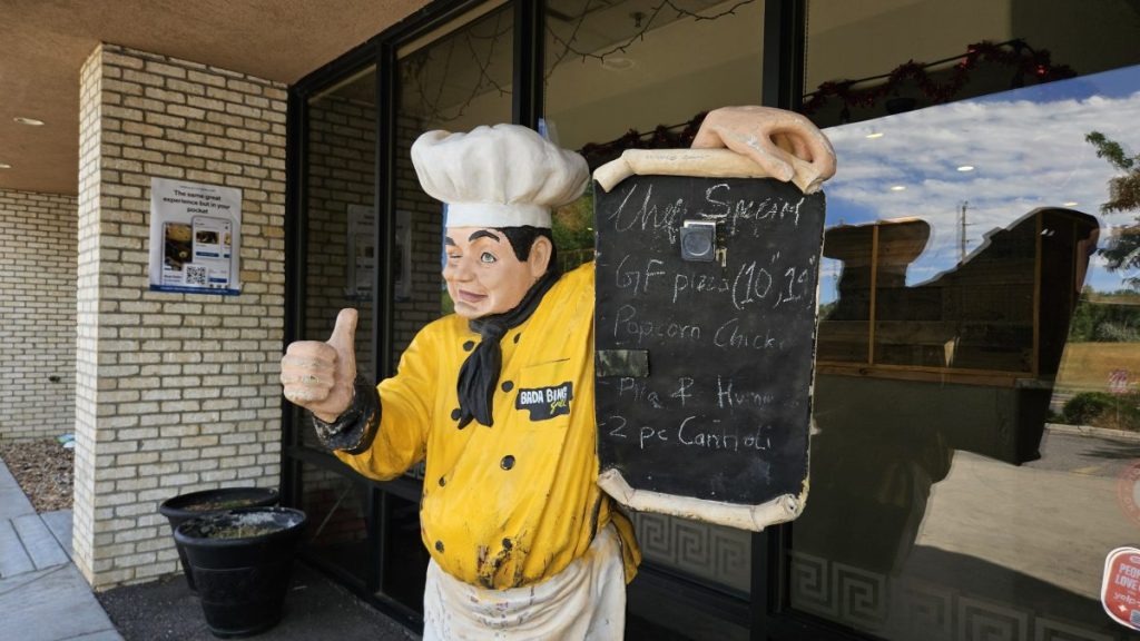 chef statue holding a menu board