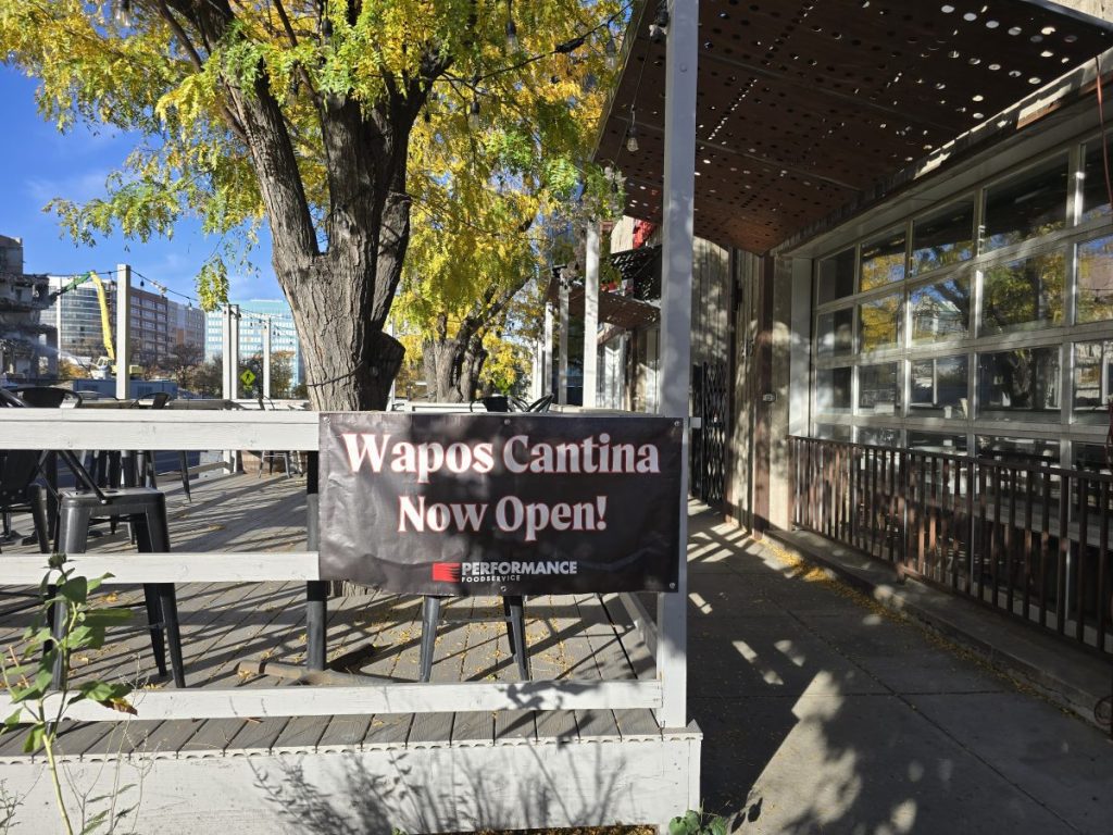 "now open" banner on a patio