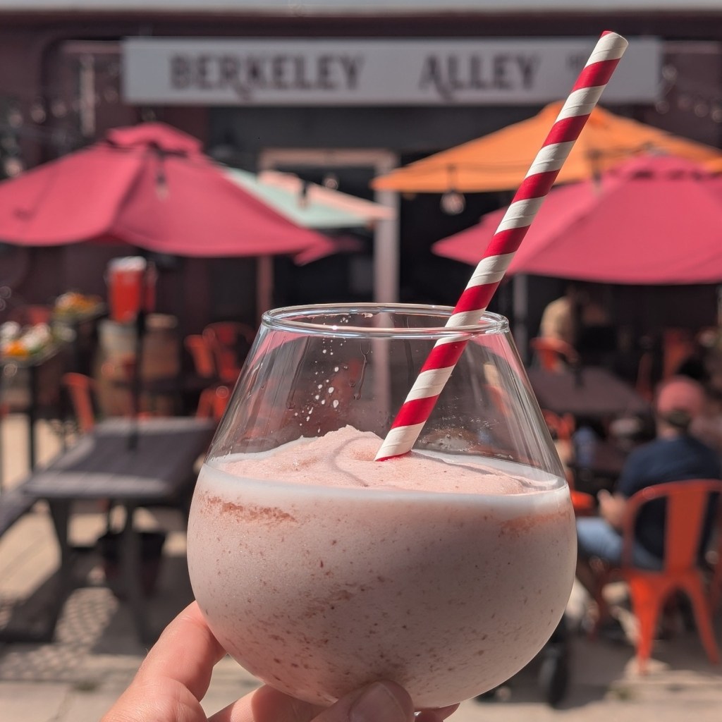 hand holding a frozen drink in a glass