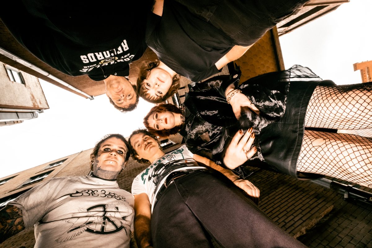 members of punk band Destiny Bond look down at the camera