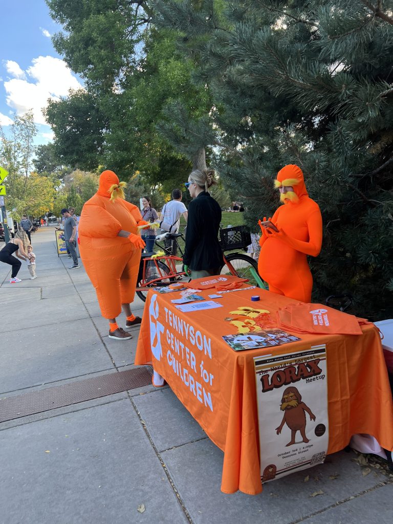 Lorax behind a booth