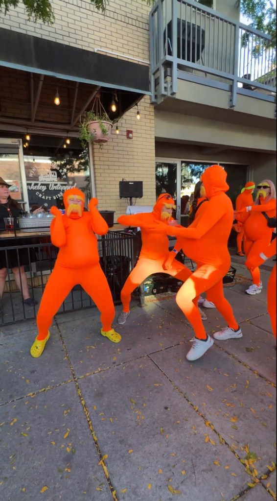 People in lorax costumes dance