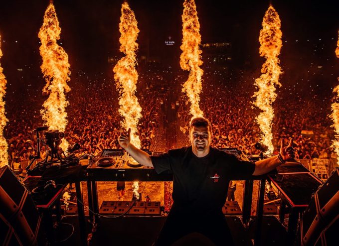 Martin Garrix dj's with pyrotechnics in the background