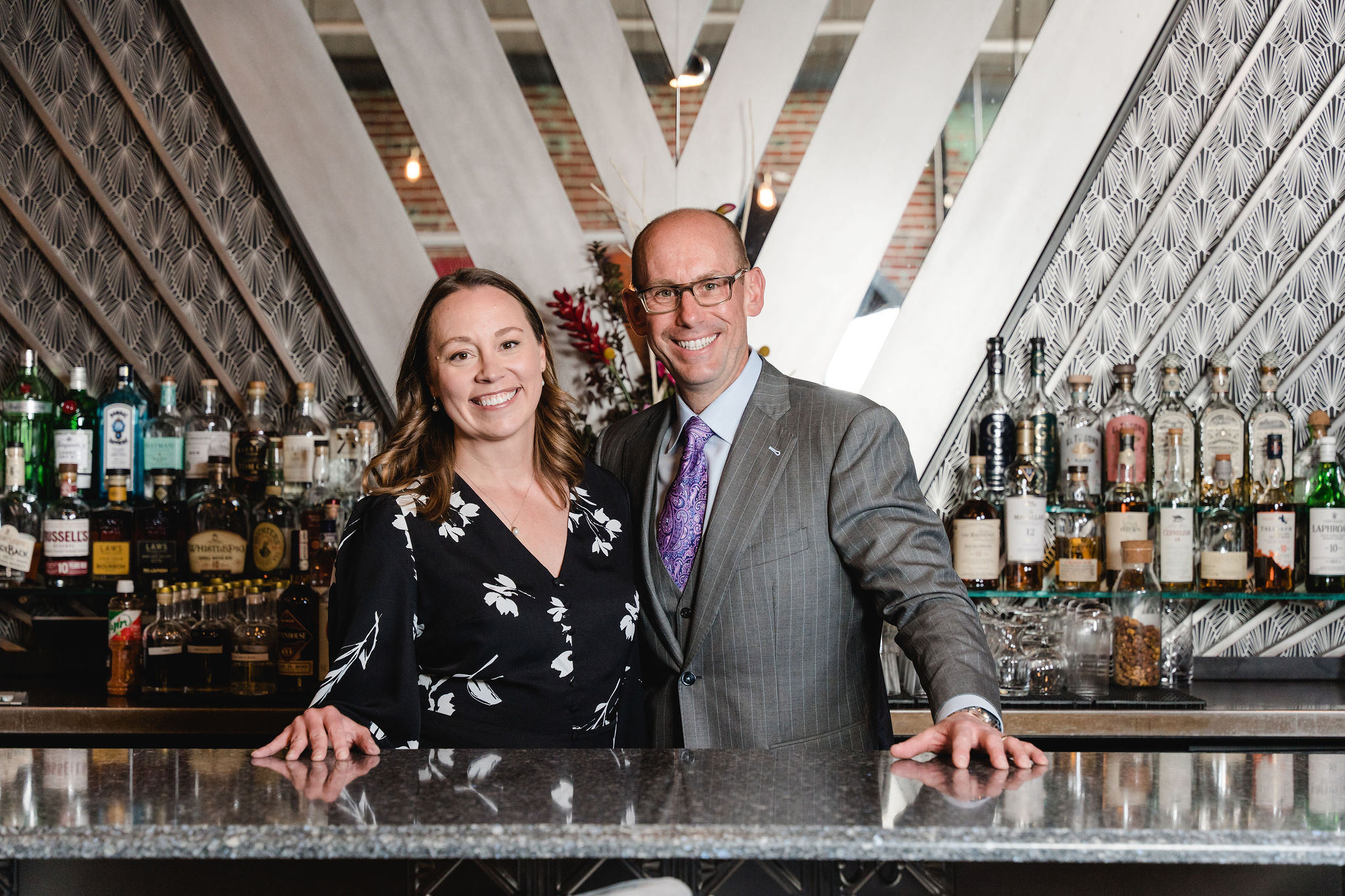 a couple behind a bar