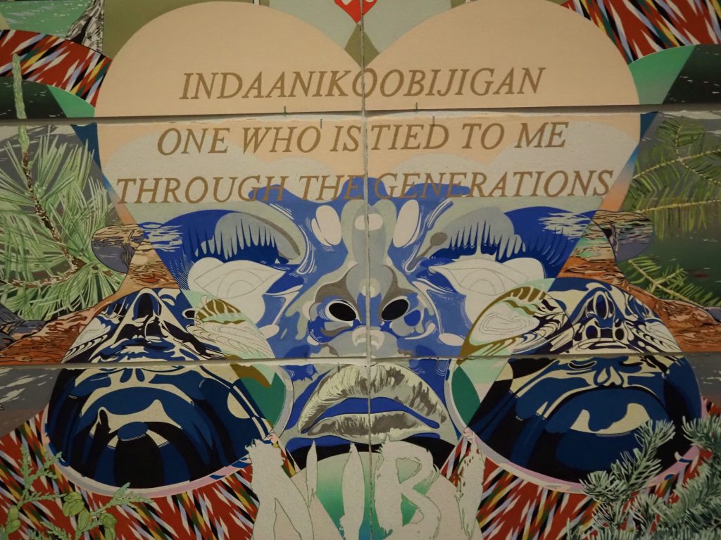 A colorful artwork of a blue face in the shape of a heart