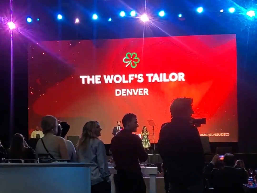 people standing in front of a large screen