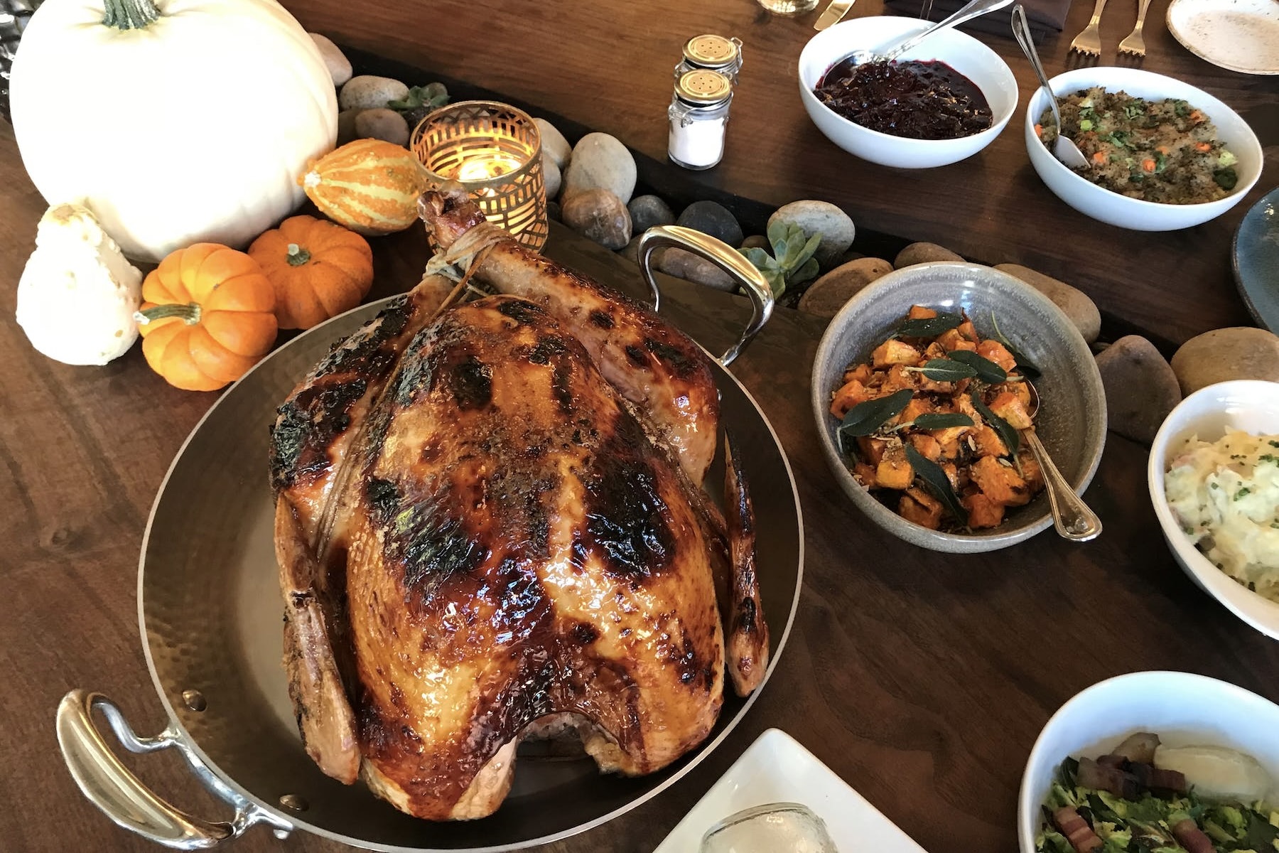 A whole cooked turkey alongside yams, stuffing and other sides from Urban Farmer