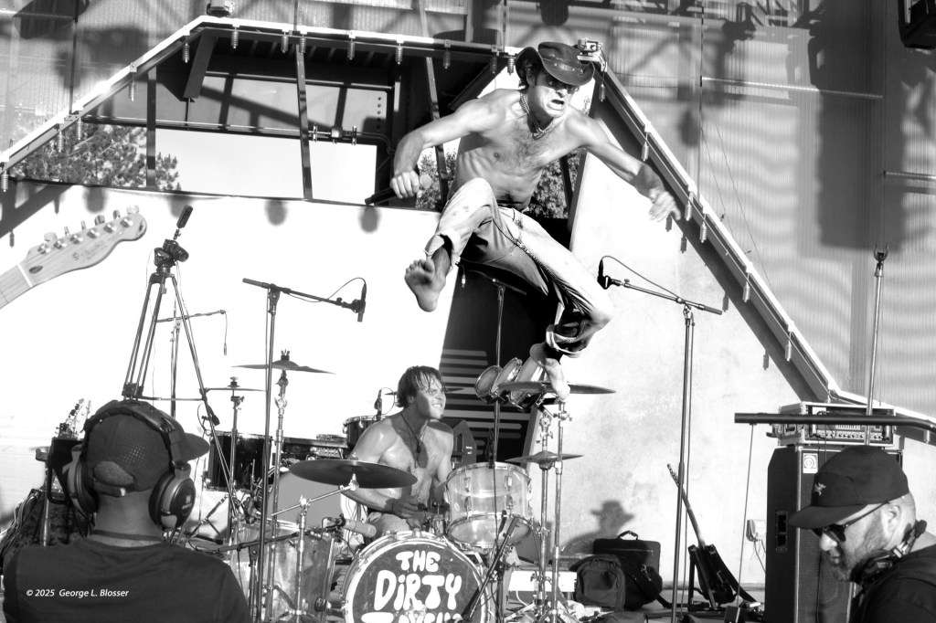 man in a band jumping on stage