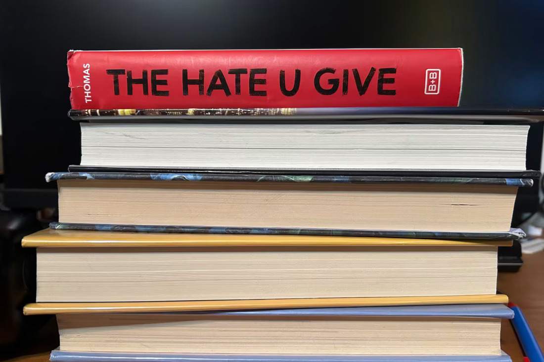 stack of books and the Hate U Give