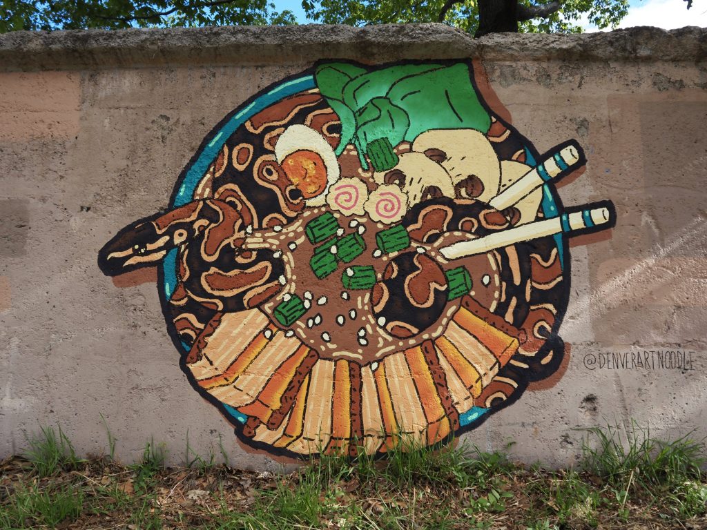 A mural of a snake in a bowl of ramen