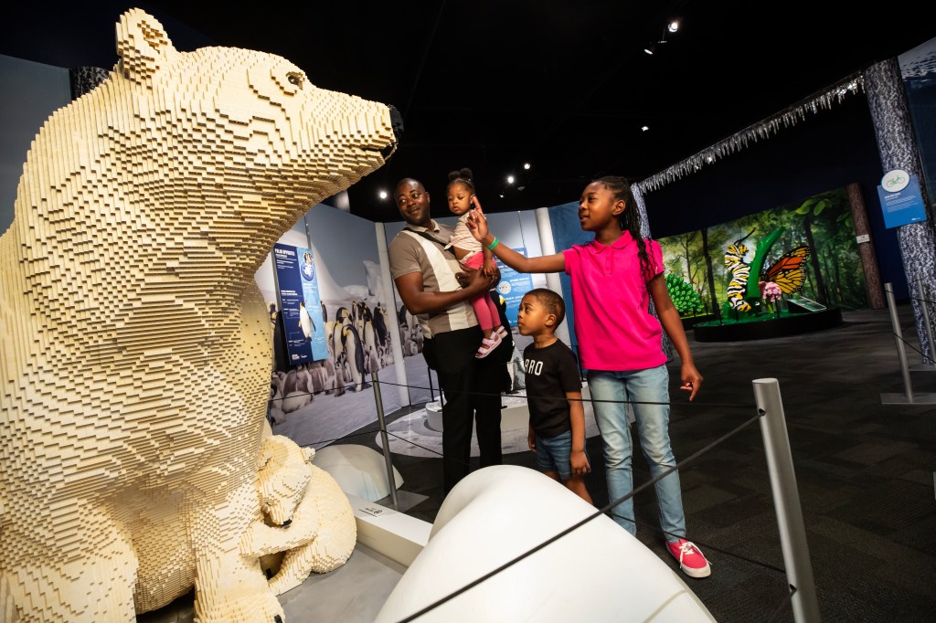 A family next to polar bears made out of LEGOs.