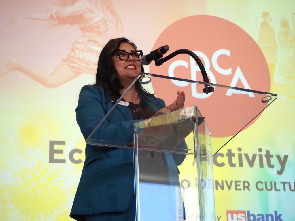 a woman at a microphone and podium