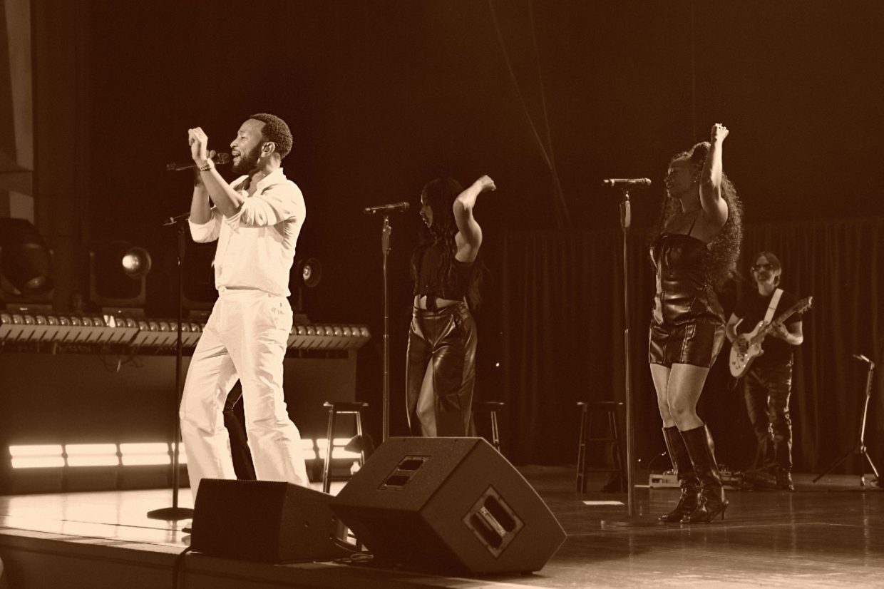 John Legend performing on stage.