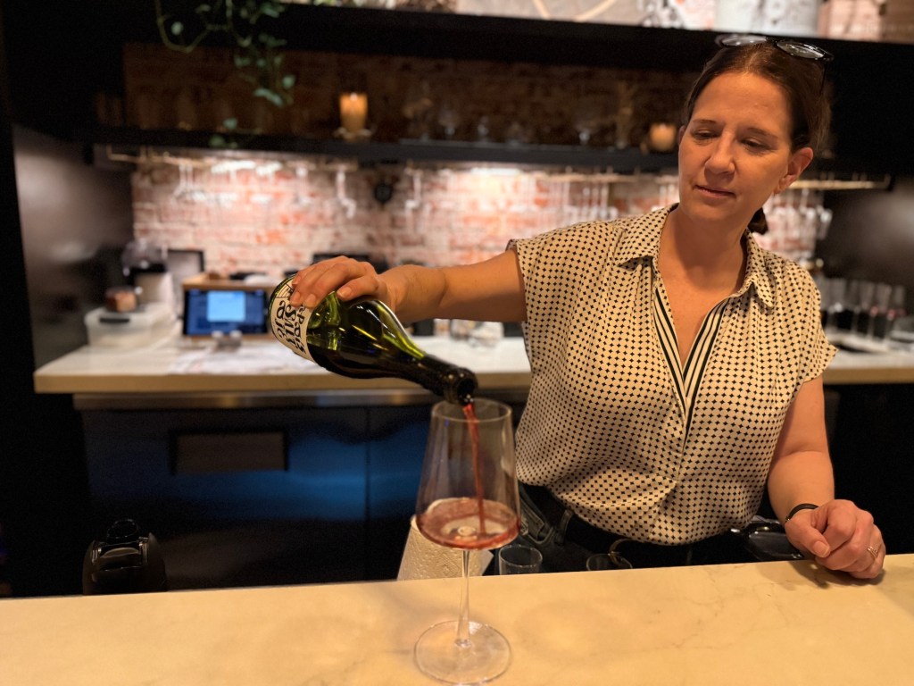 a woman pouring wine