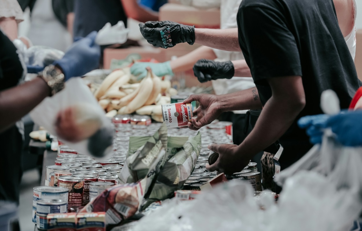 man gives away soup at food bank