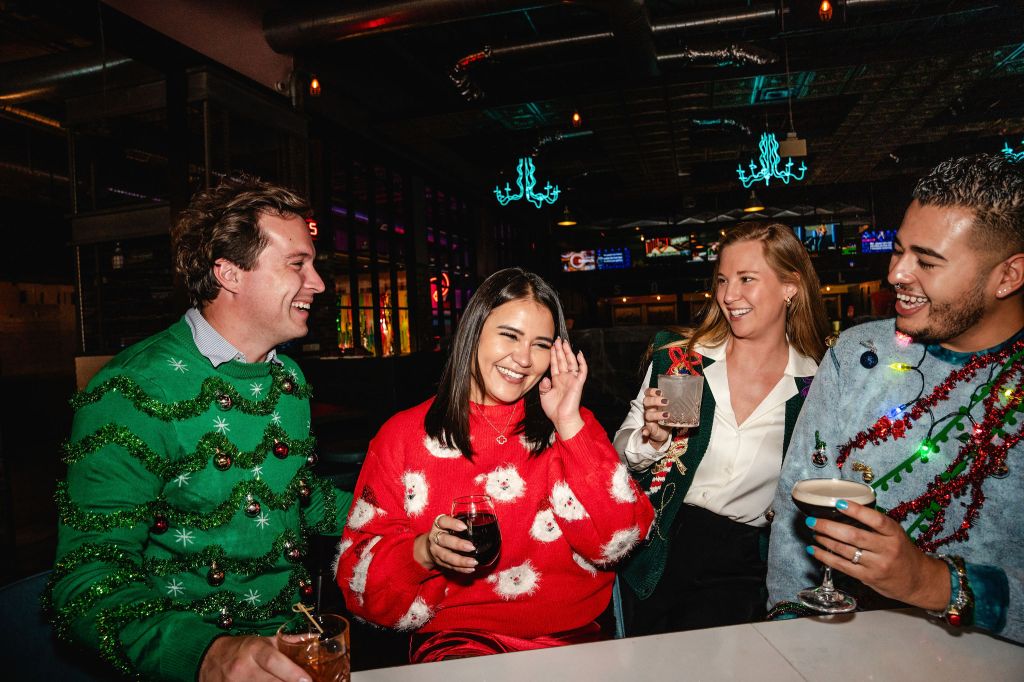 people in holiday sweaters