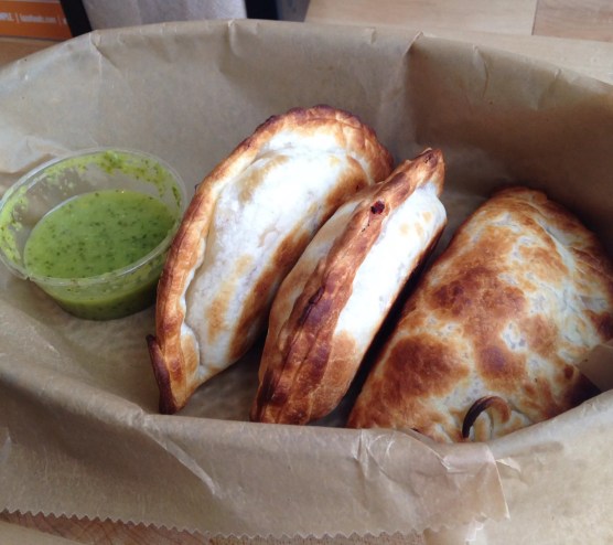three empanadas in a basket