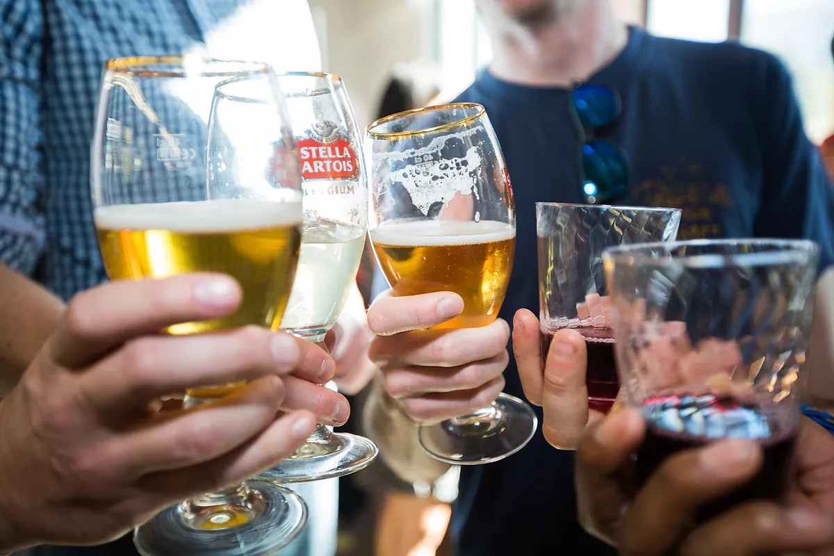 hands holding various glasses