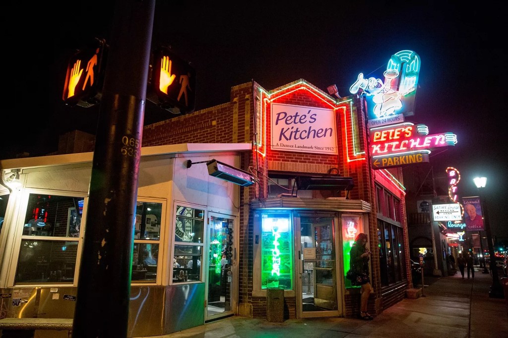 the outside of a diner with a neon sign