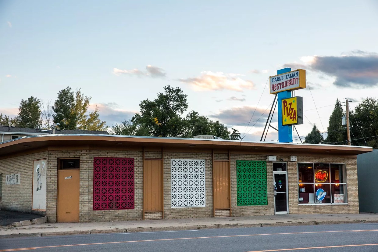 exterior of a building with a "carl's pizza" sign