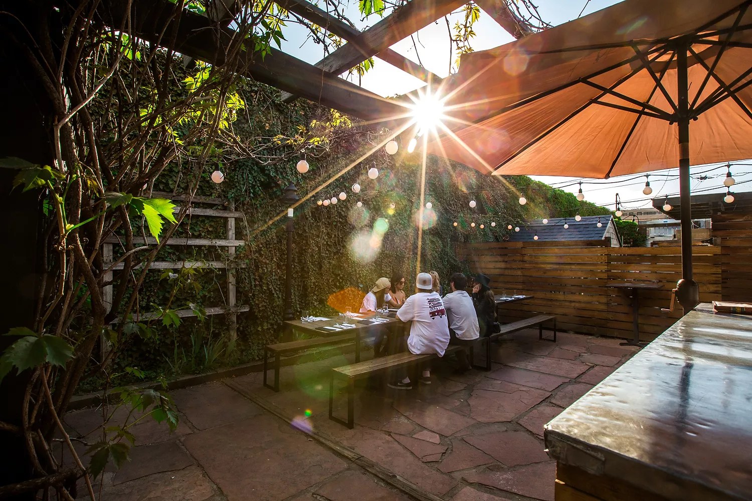 people sitting at a table on a patio