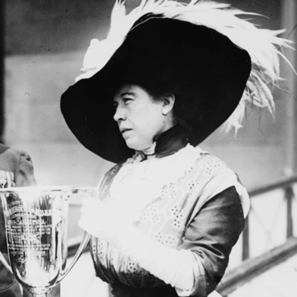A woman in a big feathered hat