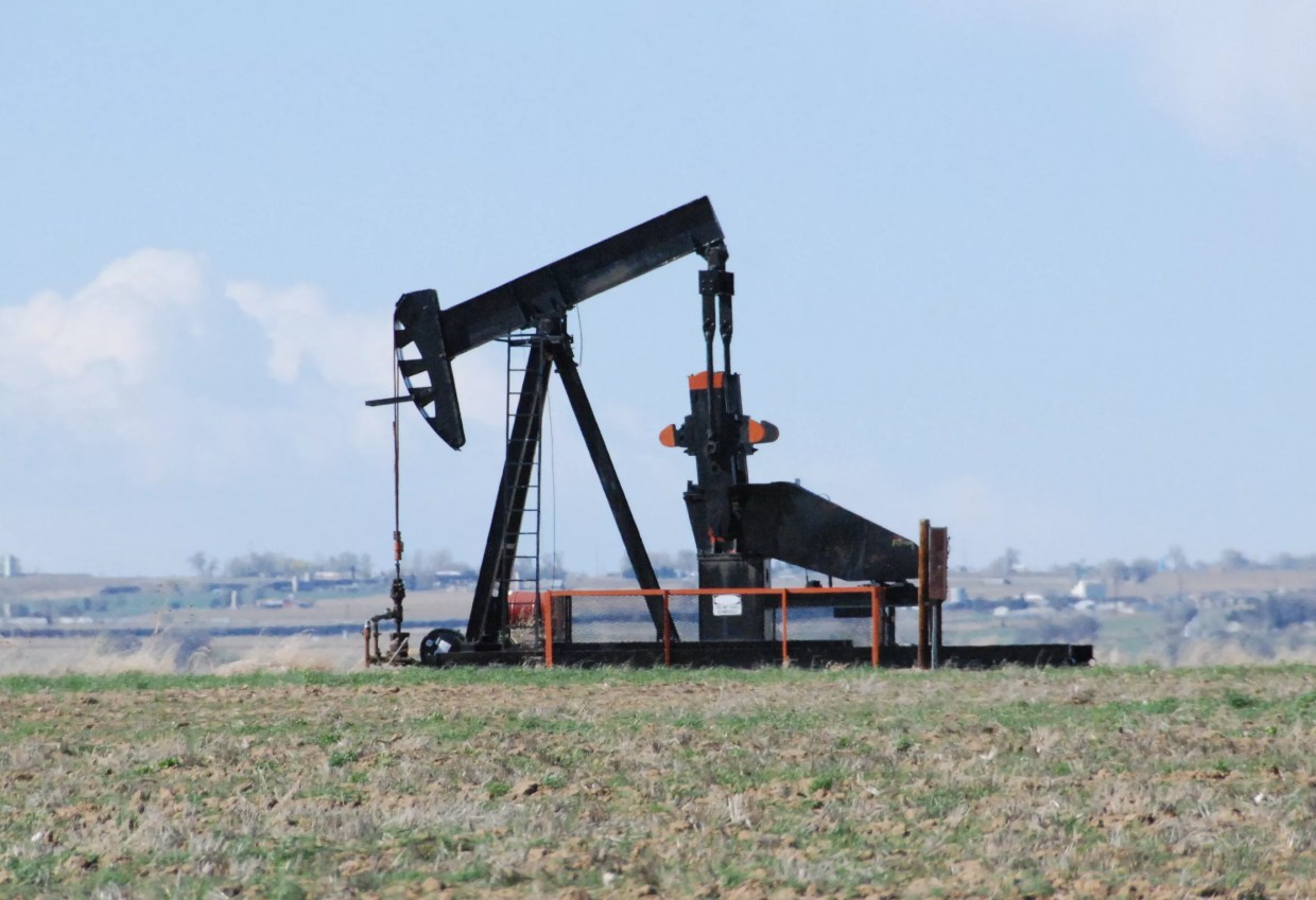 Oil well sits in front of blue sky
