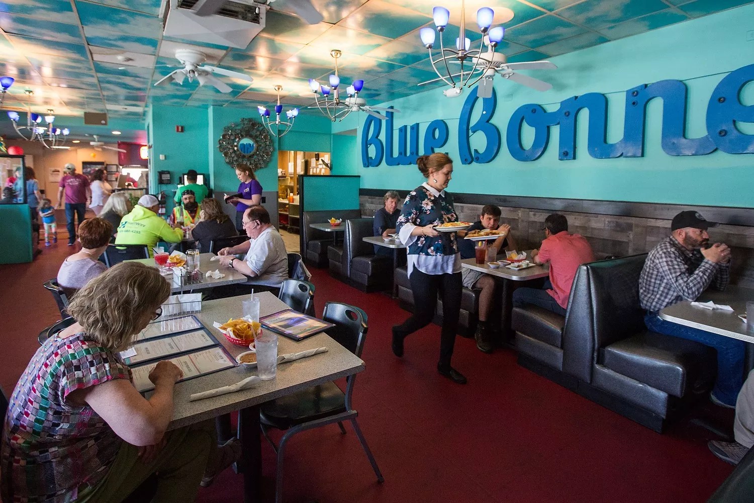 people at booths in a restaurant