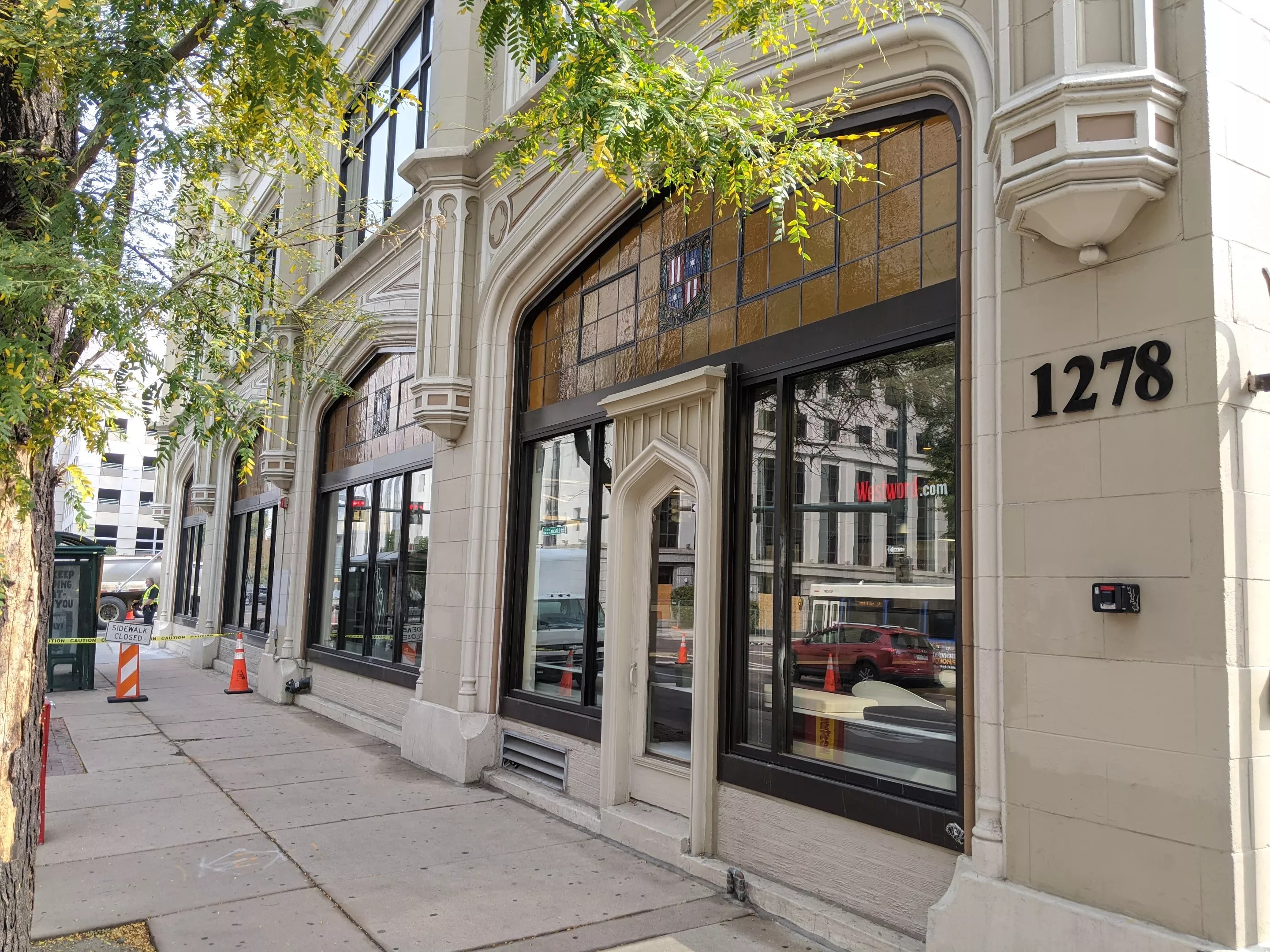 An old tan building with curved windows.