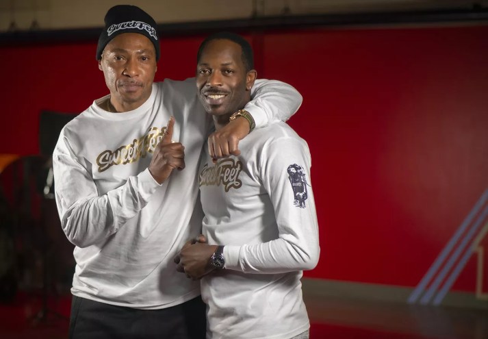 A father and son embrace.