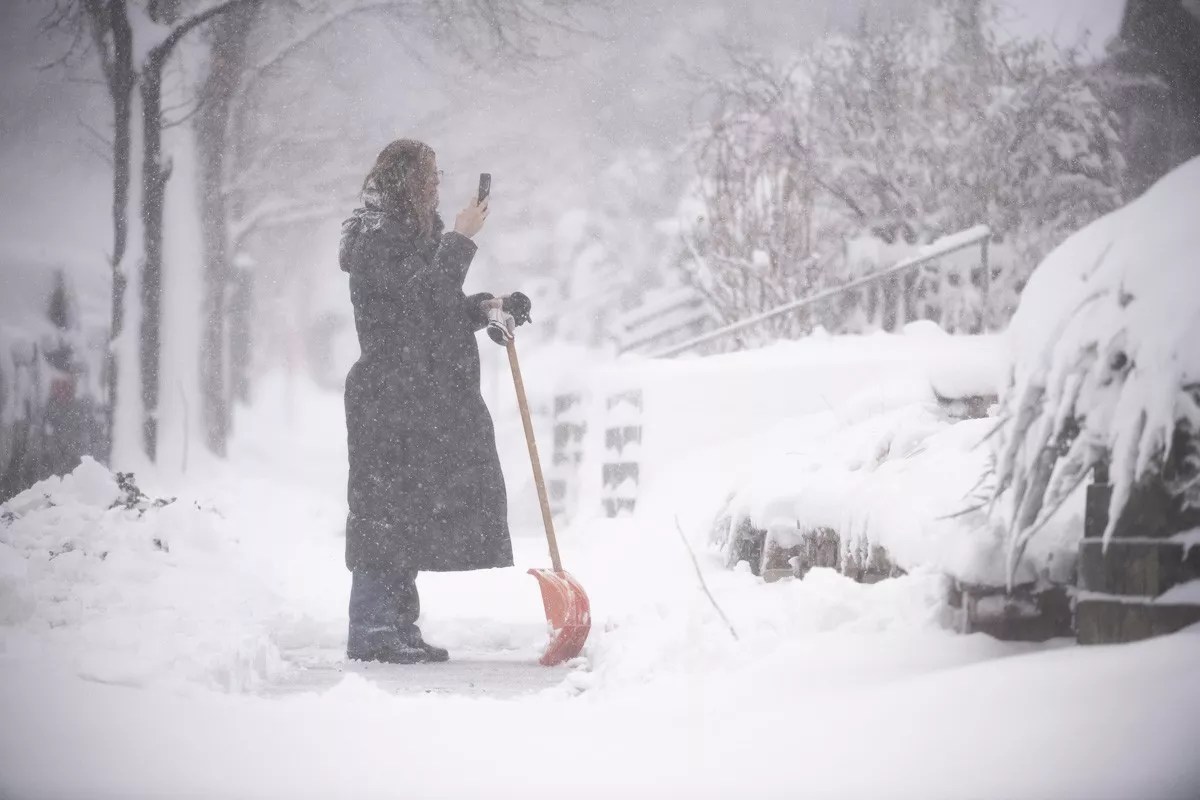 Woman takes photo of snow in Denver while shoveling her sidewalk