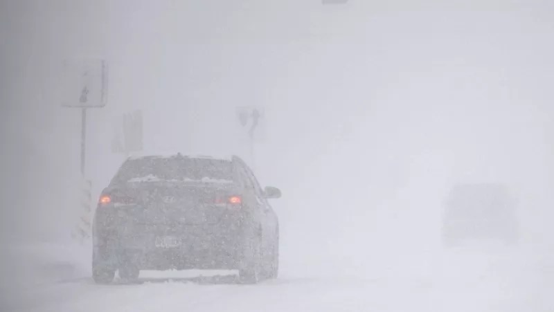 Car drives through snowstorm