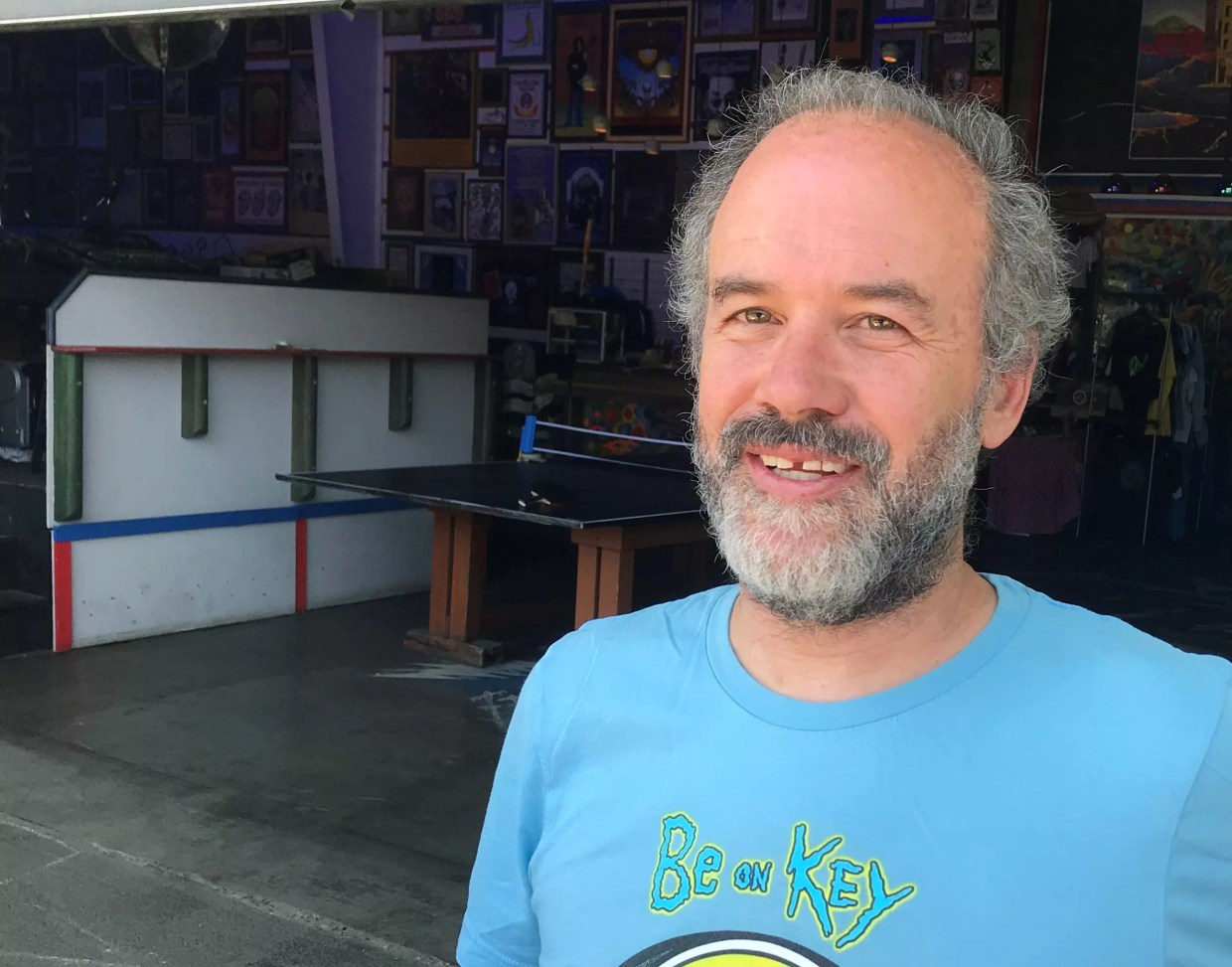 Man in blue shirt on porch