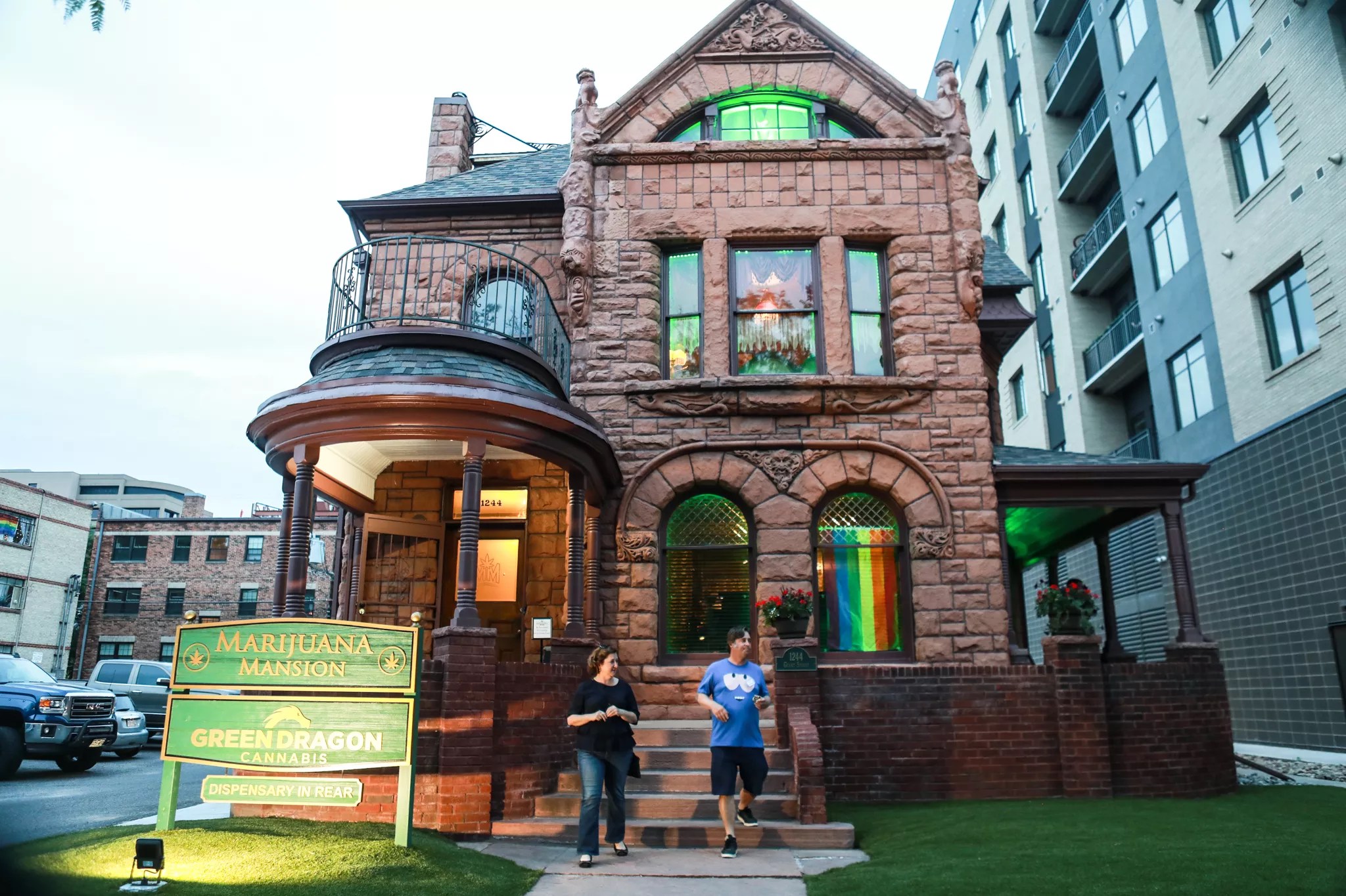 People stand outside of Denver's Marijuana Mansion in Capitol Hill