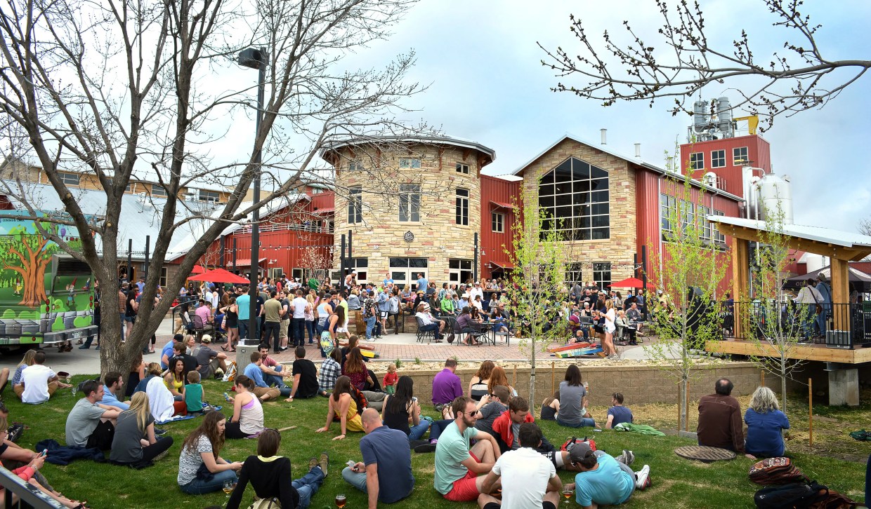 people sit outside a brewery