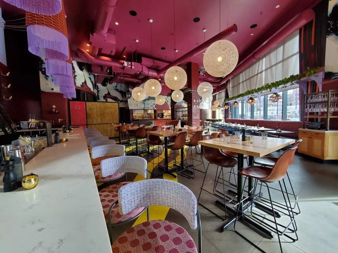 interior of a restaurant with a pink ceiling