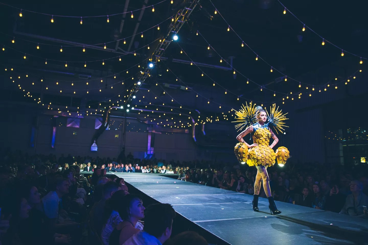 woman wearing a yellow dress on a runway