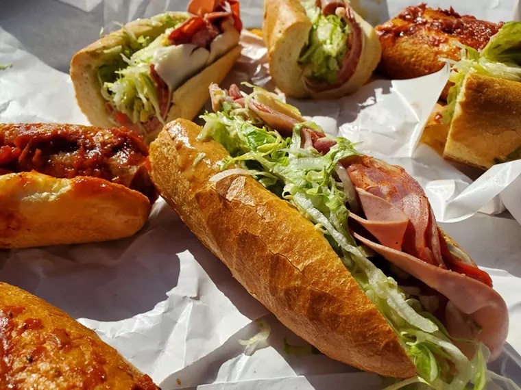 several sandwiches on long rolls